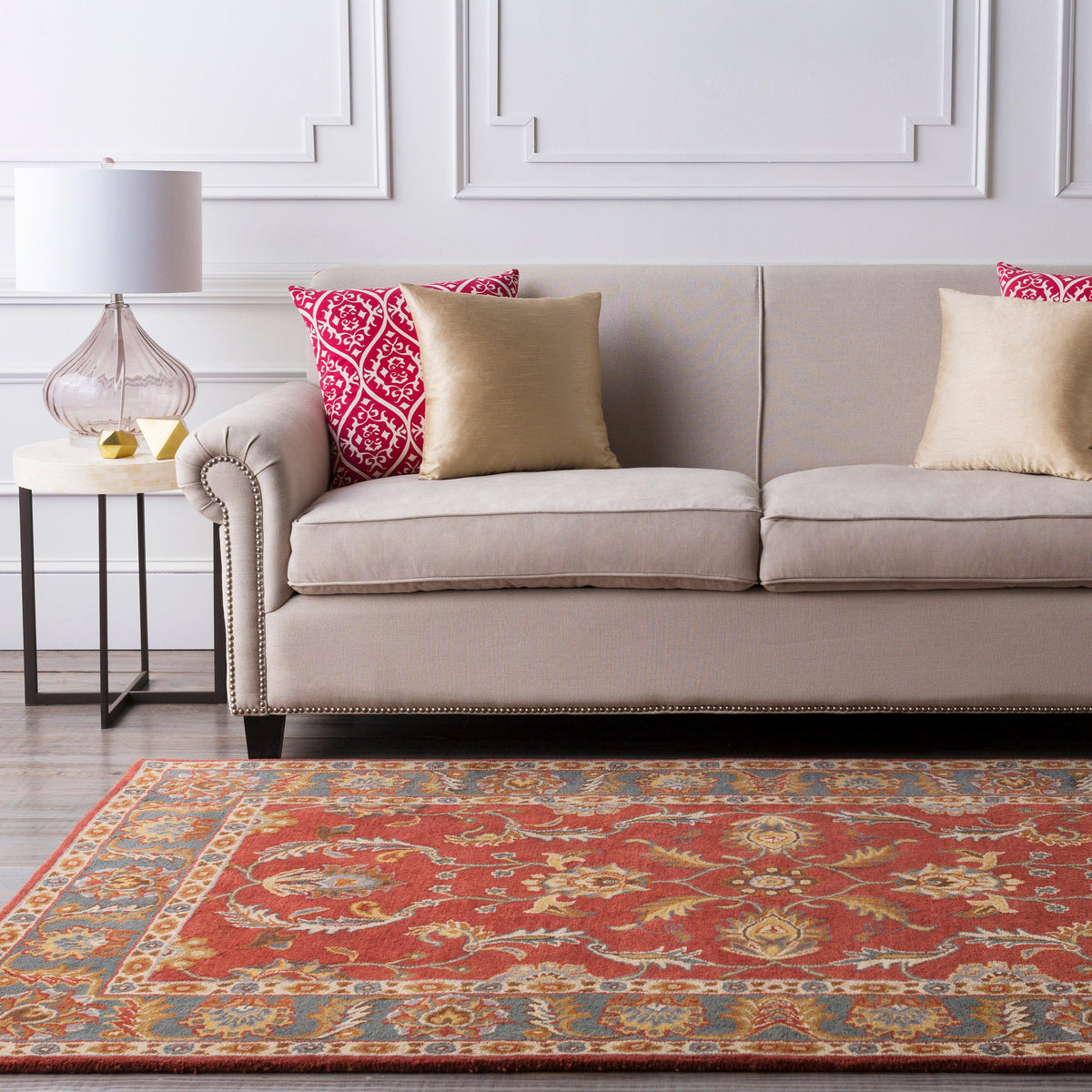 Nobility Rust Hand-Tufted Rug with traditional floral patterns in a living room setting.