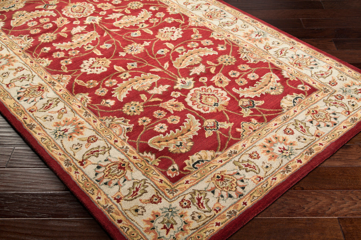 Lucia Cinnamon hand-tufted wool rug with a deep red and beige floral design on dark wood floors.