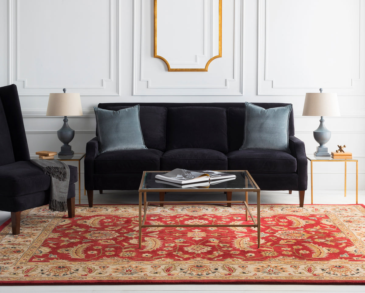 Lucia Cinnamon hand-tufted wool rug with a classic red and gold floral design in a living room.