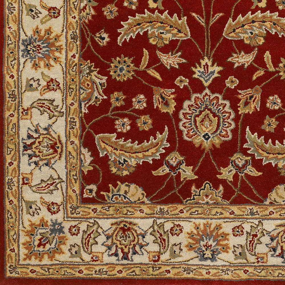 Lucia Cinnamon hand-tufted wool rug featuring a deep red field with traditional floral patterns and cream borders.