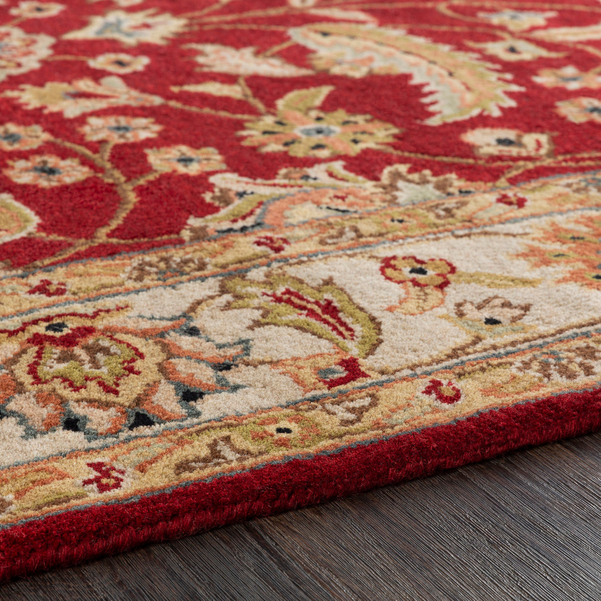 Lucia Cinnamon hand-tufted wool rug with red and beige floral patterns on dark wood floor