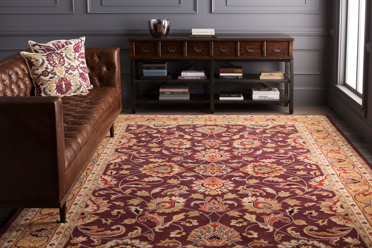 Nobility Amethyst hand-tufted wool rug in rich burgundy with tan and navy floral patterns.