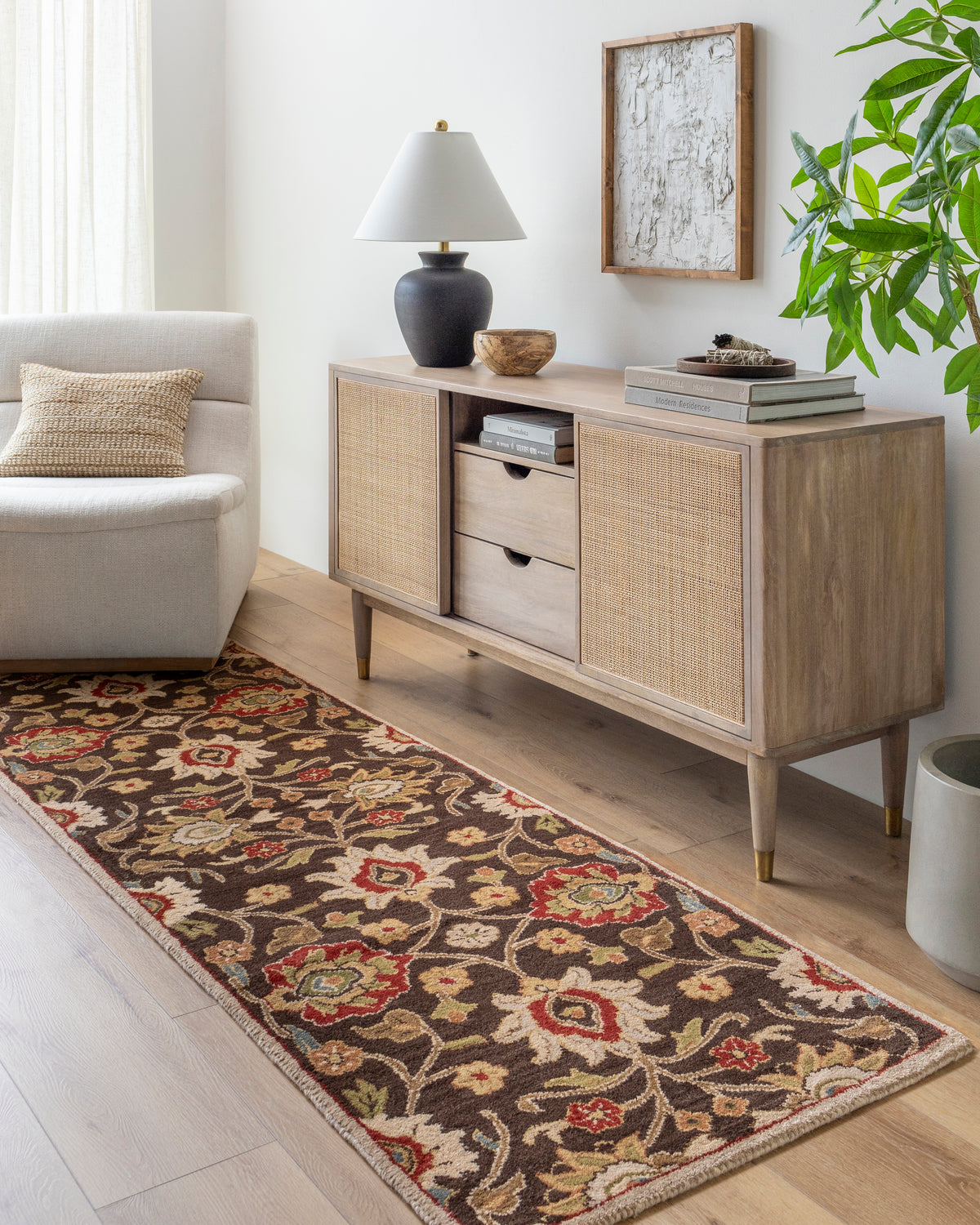 Mediterranean Umber hand-tufted wool runner rug with floral patterns in a modern living room.