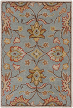 Mediterranean Cerulean hand-tufted wool rug with a classic floral pattern in blue, gold, and rust.