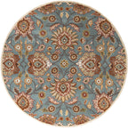 Round blue hand-tufted wool rug with a classic floral pattern in brown and beige.