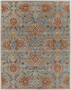 Mediterranean Cerulean hand-tufted wool rug with a classic floral pattern in blue, beige, and rust.