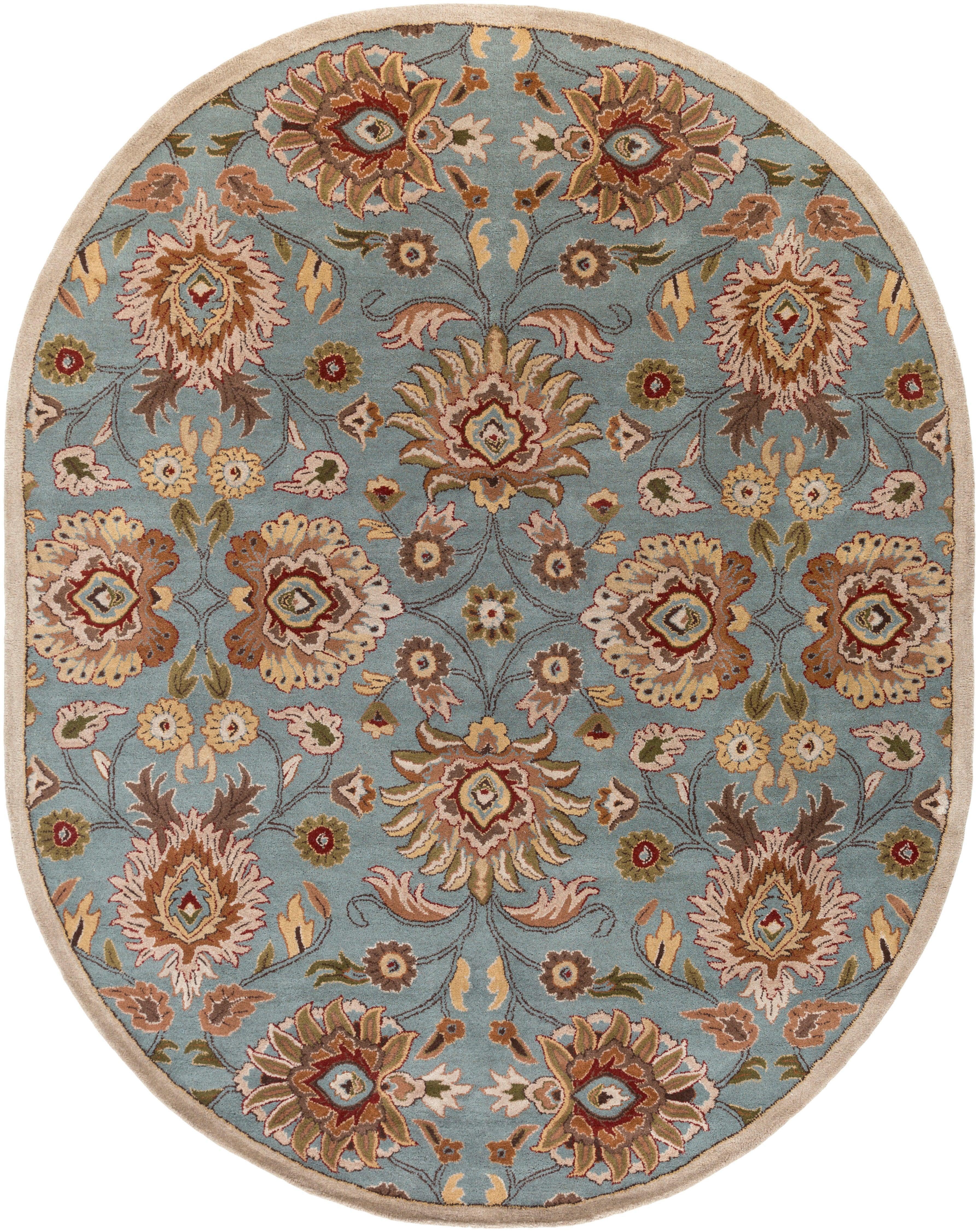 Oval Mediterranean cerulean blue wool rug with a hand-tufted floral pattern.