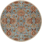 Round Mediterranean cerulean blue hand-tufted wool rug with a classic floral pattern.