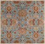 Mediterranean Cerulean hand-tufted wool rug with a classic floral pattern in blue, beige, and brown.