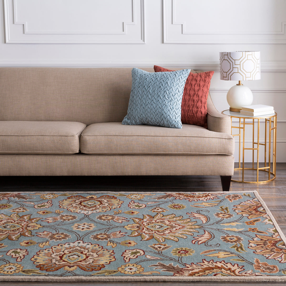 Mediterranean Cerulean hand-tufted wool rug with a blue and beige floral pattern in a living room.
