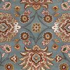 Mediterranean Cerulean hand-tufted wool rug featuring a classic floral pattern in warm blue, brown, and beige.