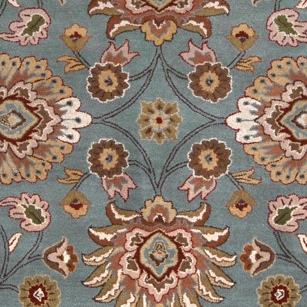 Mediterranean Cerulean hand-tufted wool rug featuring a classic floral pattern in warm blue, brown, and beige.