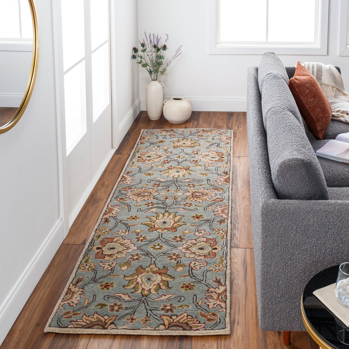 Mediterranean Cerulean hand-tufted wool runner rug with a floral pattern on hardwood floor