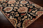 Mediterranean Ink hand-tufted wool rug with floral patterns on a black background.