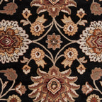 Mediterranean Ink hand-tufted wool rug with floral patterns on a black background.
