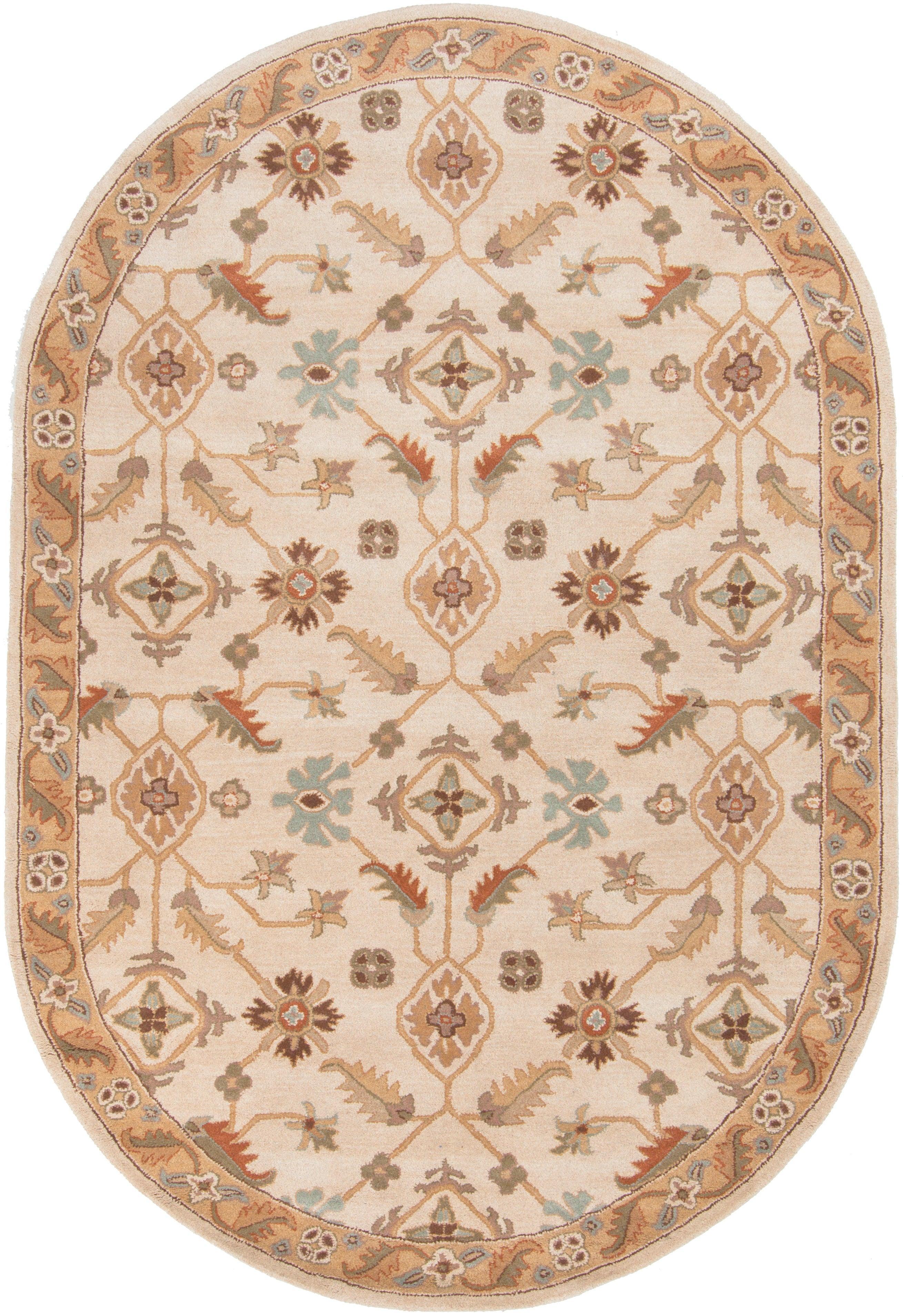 Oval Carthage Beige hand-tufted wool rug with traditional floral patterns and borders.