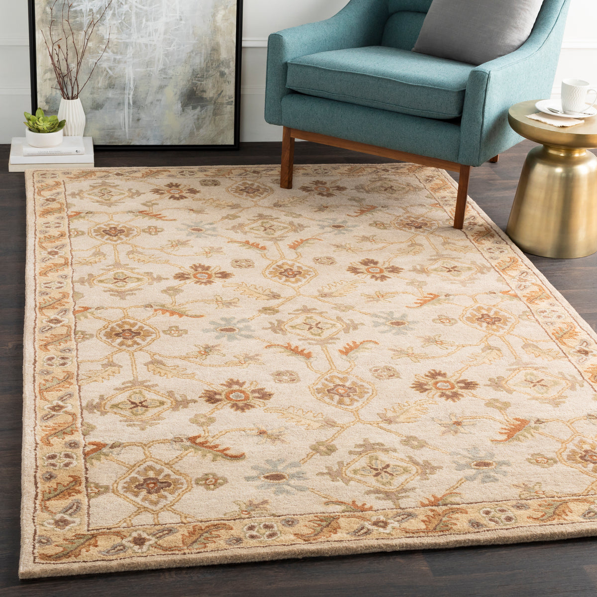 Carthage beige hand-tufted wool rug with traditional floral patterns in a living room.