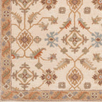 Carthage Beige hand-tufted wool rug with traditional floral motifs in tan, blue, and green.