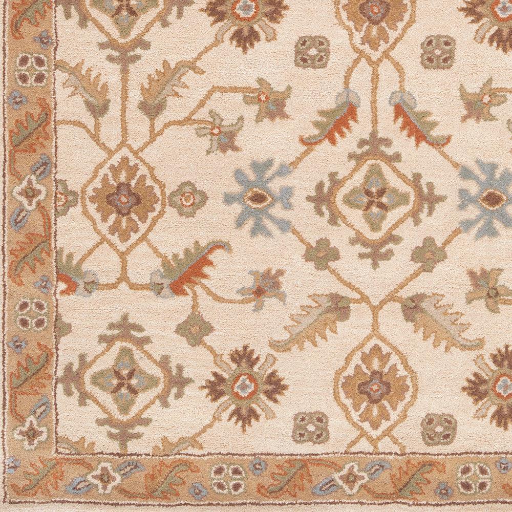 Carthage Beige hand-tufted wool rug with traditional floral motifs in tan, blue, and green.