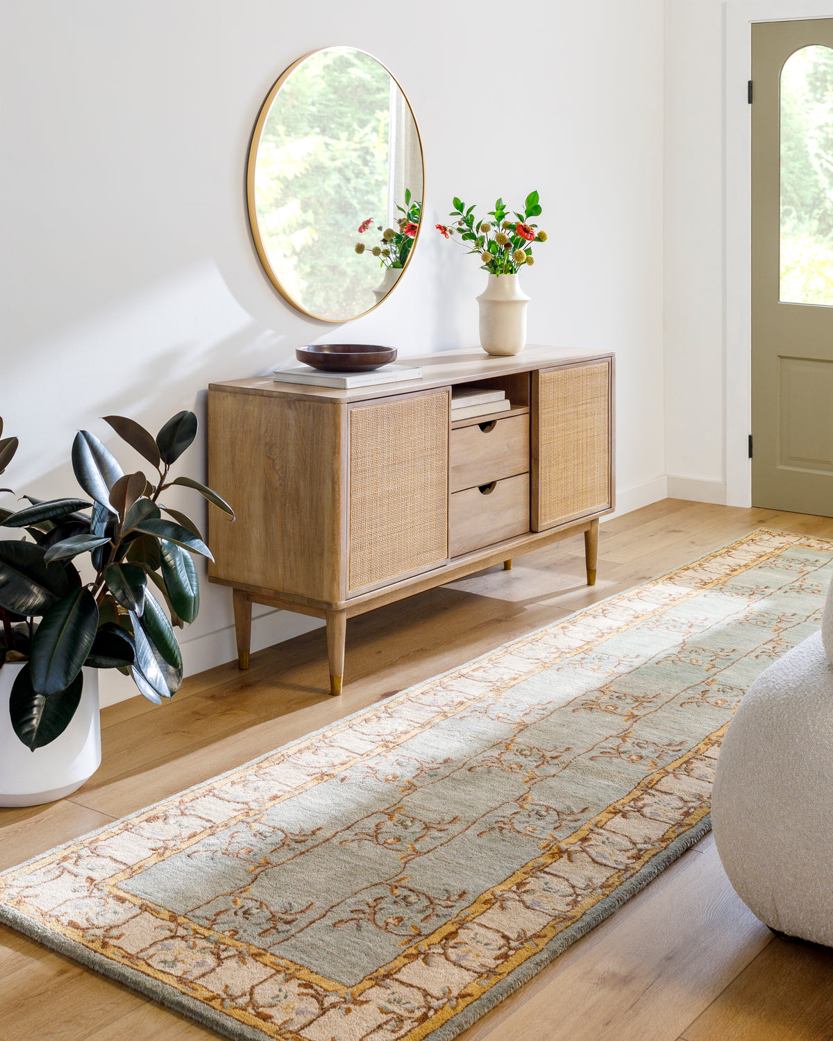 Corinth Azure hand-tufted wool runner rug with light blue and gold floral pattern in a hallway.