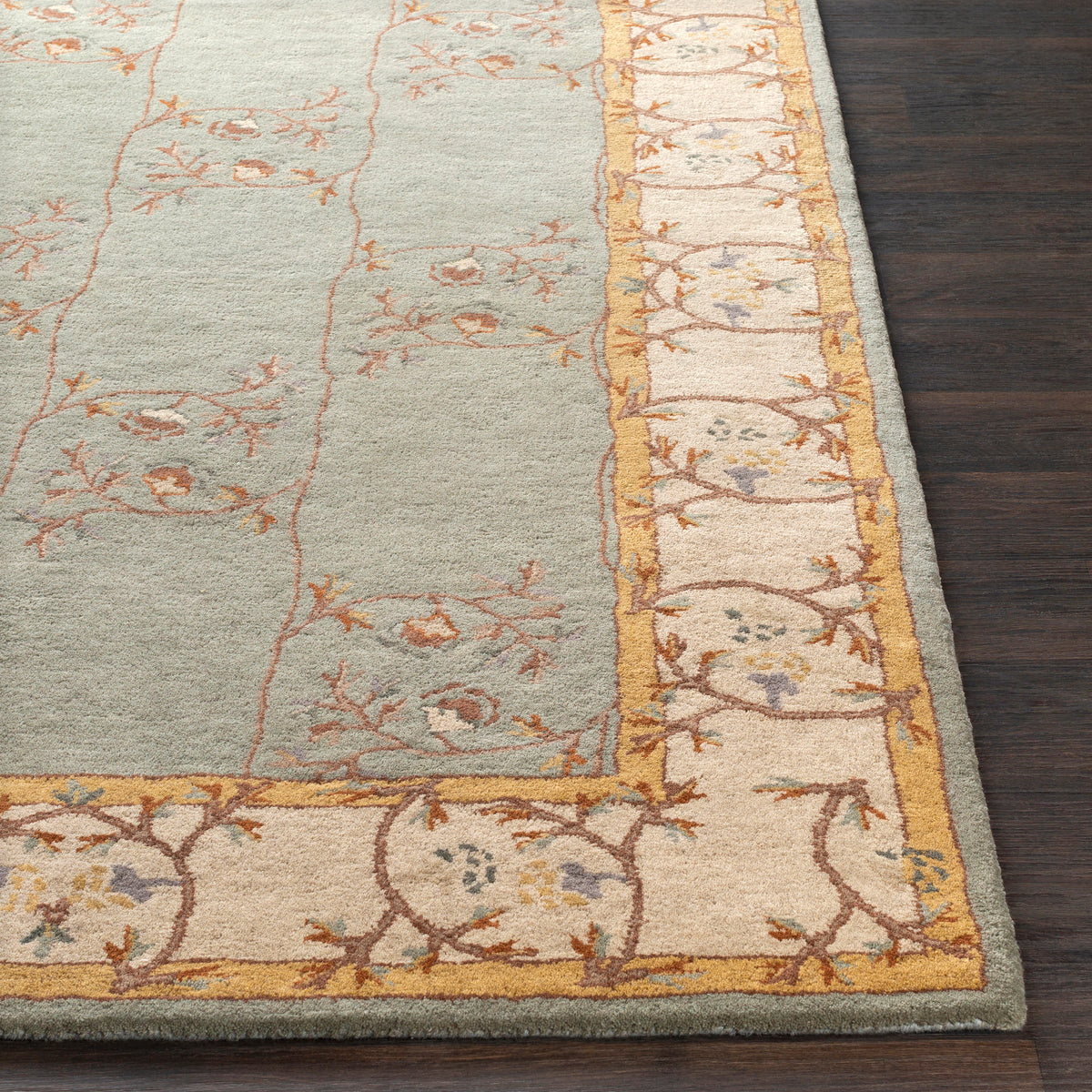 Corinth Azure hand-tufted wool rug with light blue center and cream floral border
