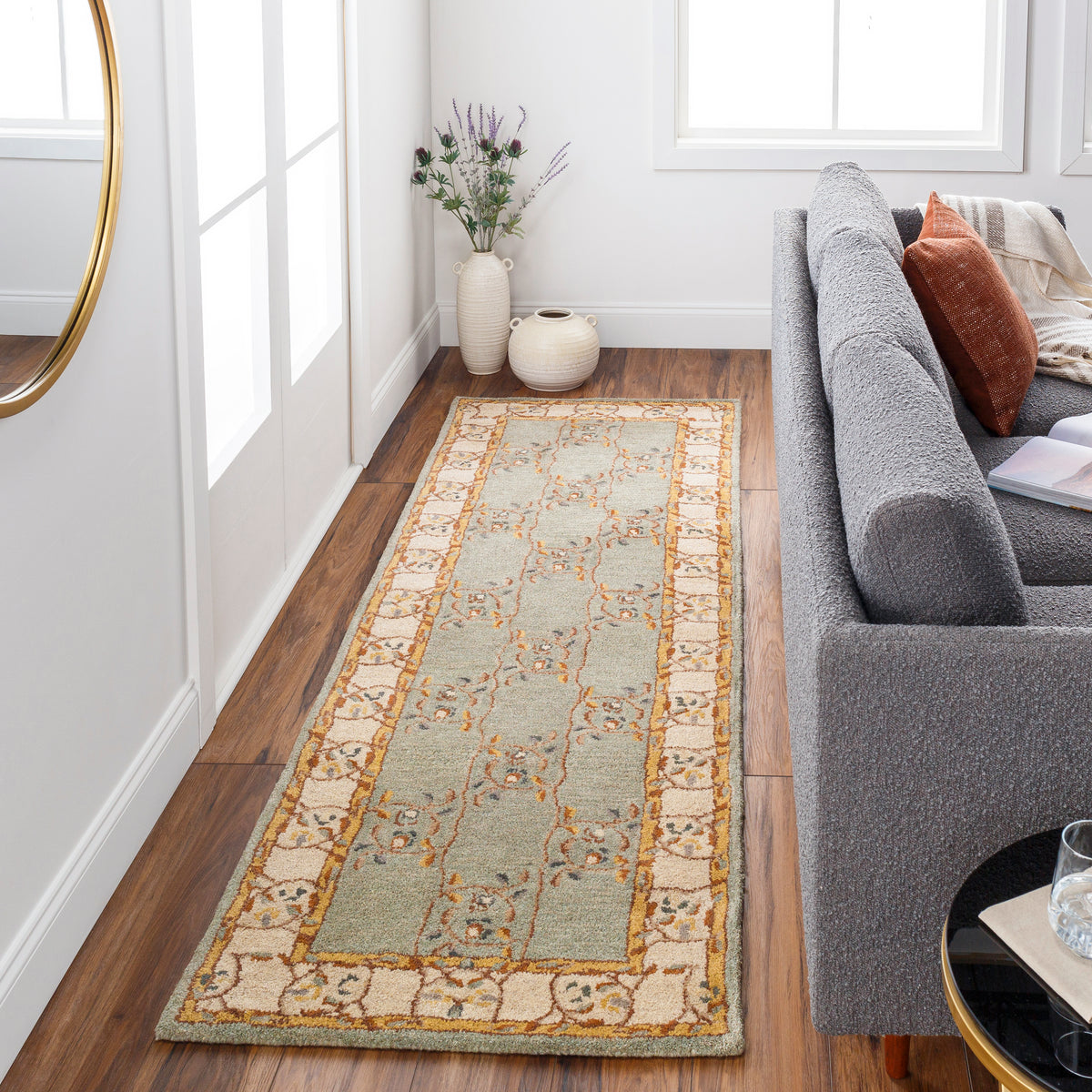 Corinth Azure hand-tufted wool runner rug with a light blue floral pattern on hardwood floor.