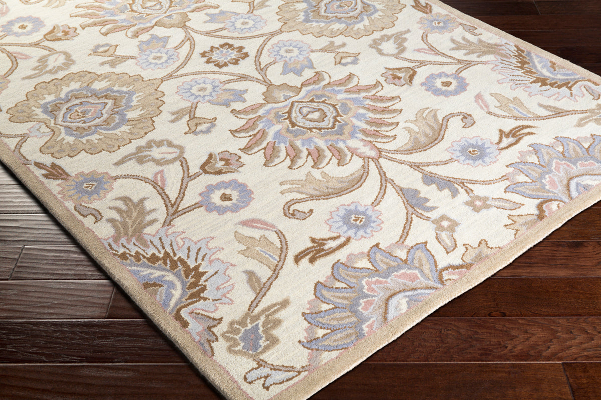 Mediterranean Lilac hand-tufted wool rug with floral patterns on dark wood floor.