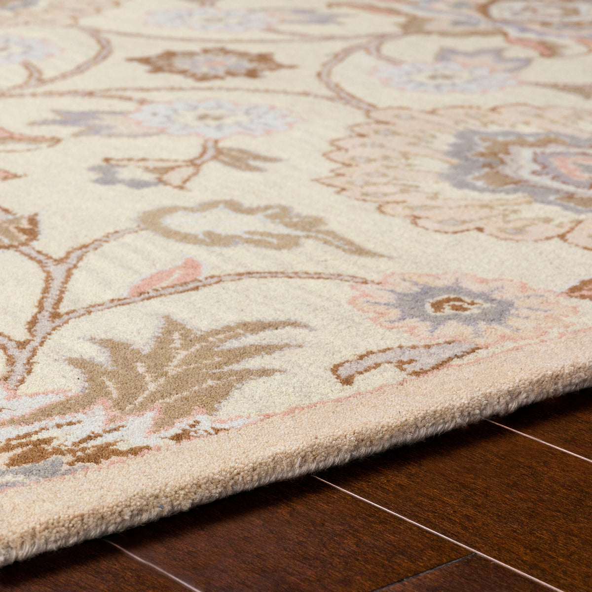 Mediterranean Lilac hand-tufted wool rug with floral patterns on dark wood floor.