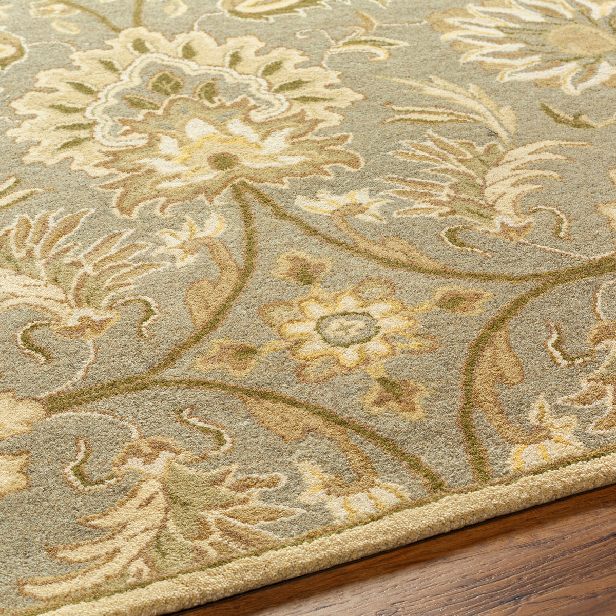 Mediterranean Sky hand-tufted wool rug with sage, ivory, and olive floral patterns.