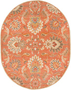Oval burnt orange Mediterranean Cider wool rug with hand-tufted floral patterns.
