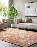 Mediterranean Cider burnt orange hand-tufted wool rug with floral patterns in a modern living room.