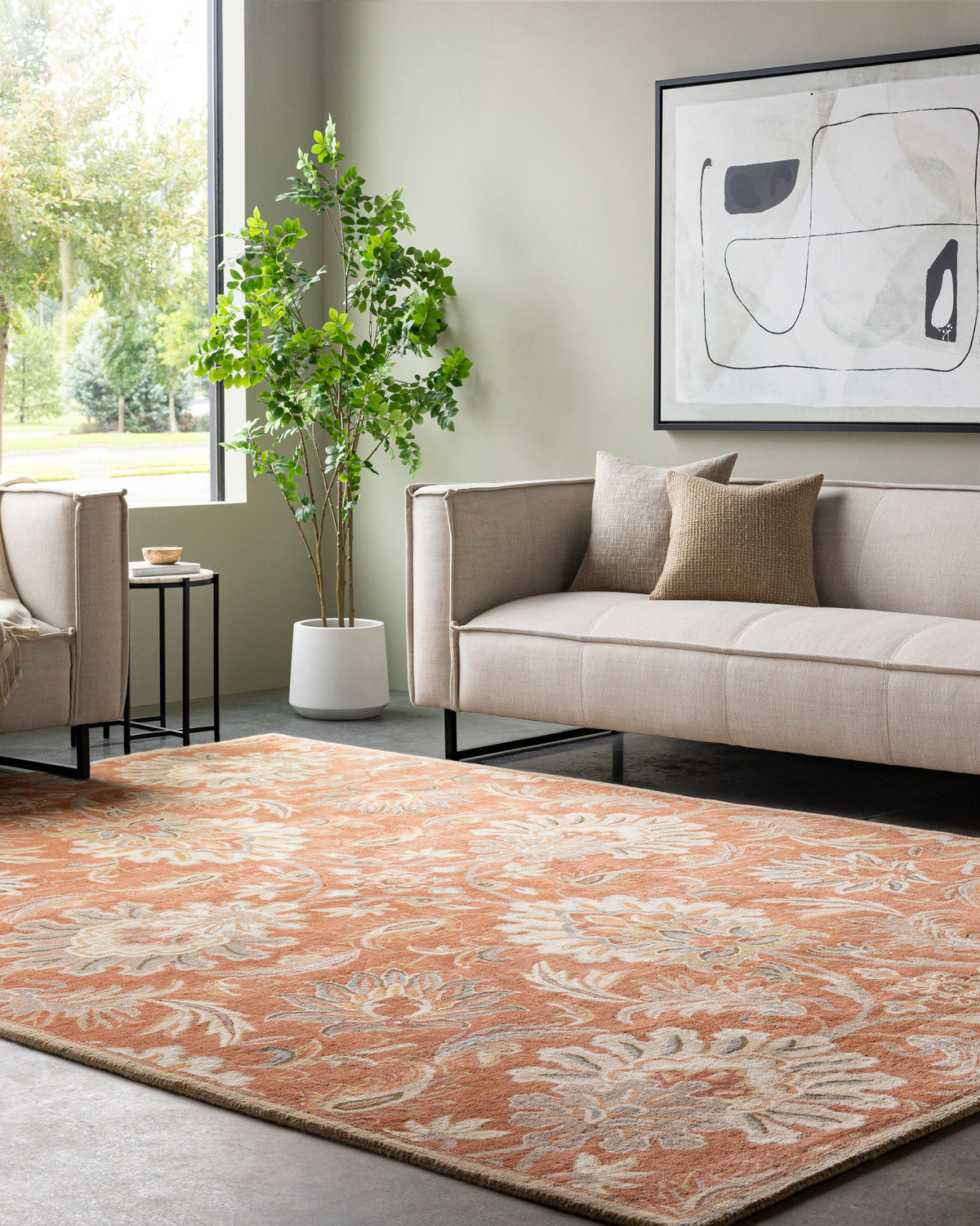 Mediterranean Cider burnt orange hand-tufted wool rug with floral patterns in a modern living room.
