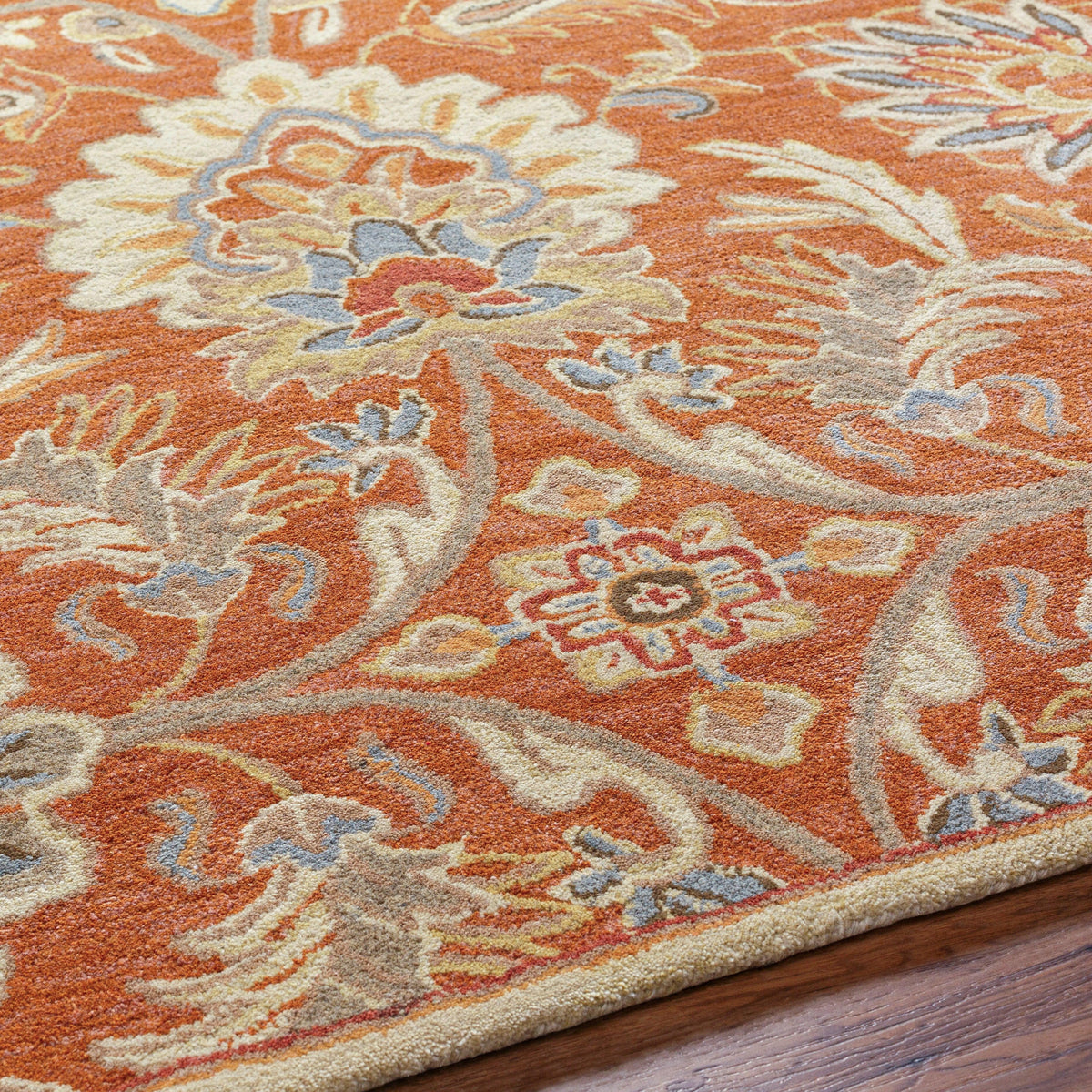 Mediterranean Cider hand-tufted wool rug with burnt orange floral patterns