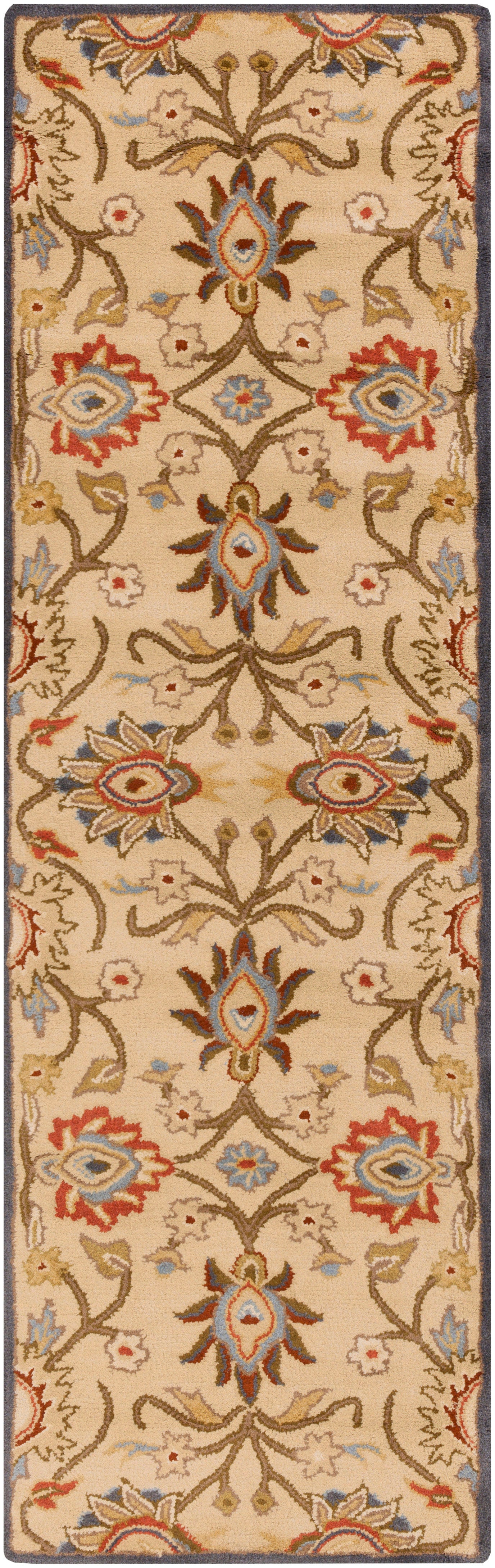 Mediterranean multi hand-tufted wool runner rug with floral patterns in red, blue, and tan.