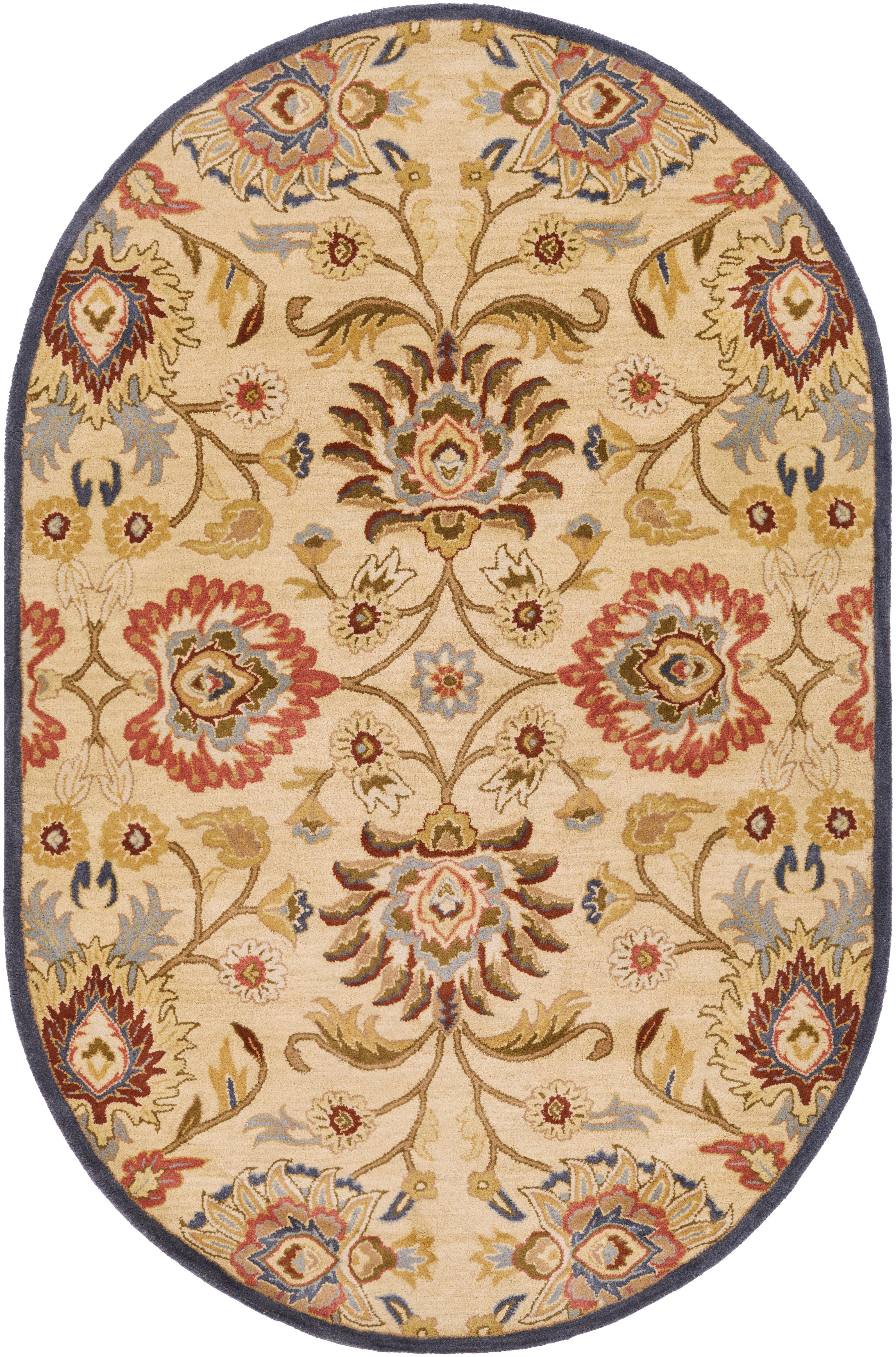 Oval Mediterranean hand-tufted wool rug with red, blue, and olive floral patterns on a tan background.