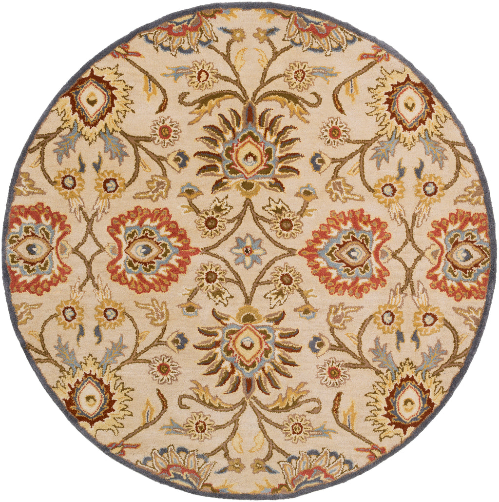 Round Mediterranean wool rug with floral patterns in red, tan, and blue.