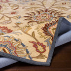 Mediterranean multi hand-tufted wool rug with floral patterns in red, blue, and tan.