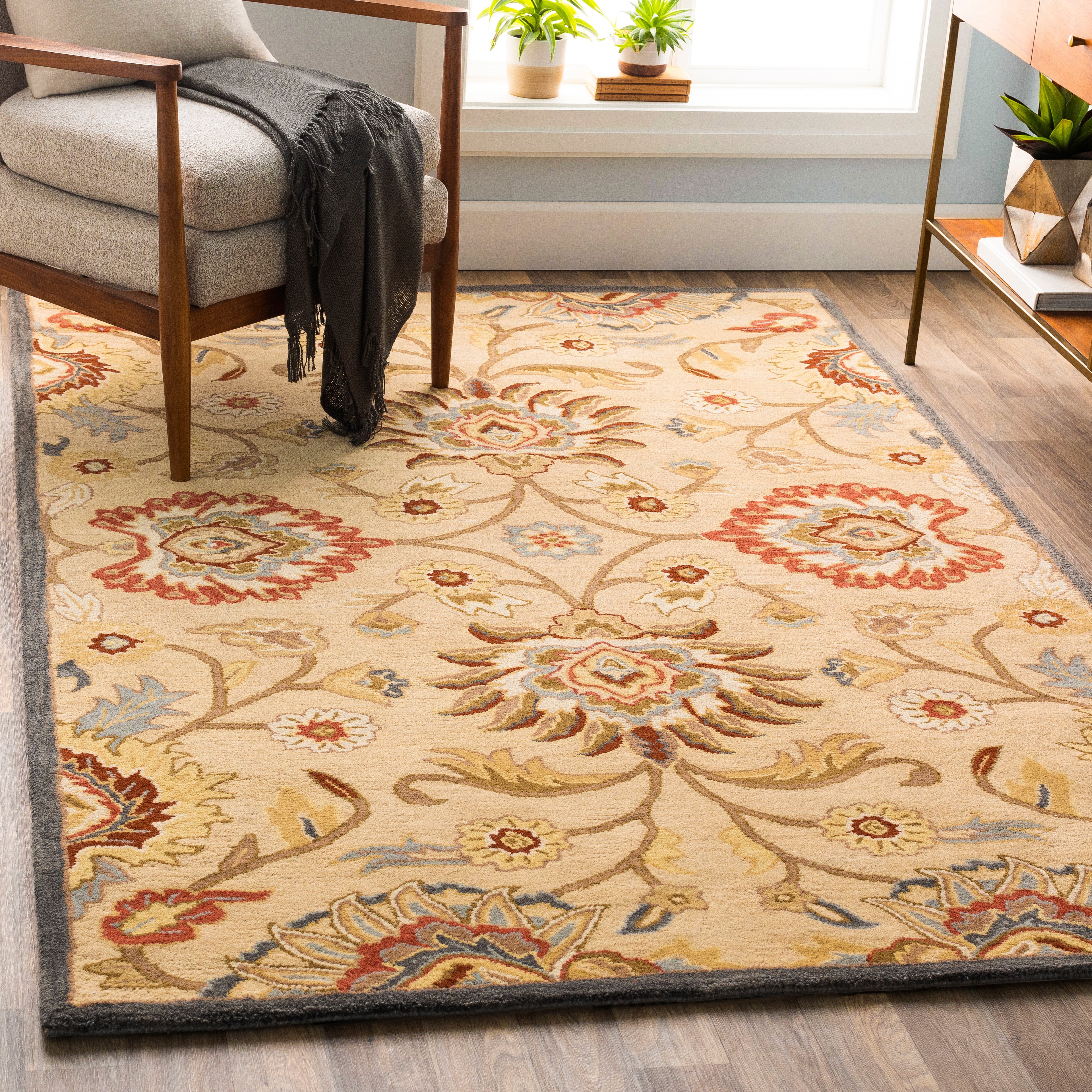 Mediterranean Multi Hand-Tufted wool rug with floral patterns in red, tan, and blue.