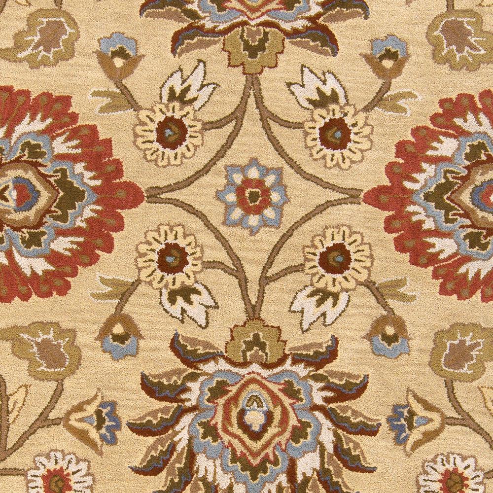 Mediterranean hand-tufted wool rug with red, blue, and olive floral patterns on a tan background.