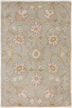Giardino Stone hand-tufted wool rug with a floral pattern in blue-grey, beige, and gold.