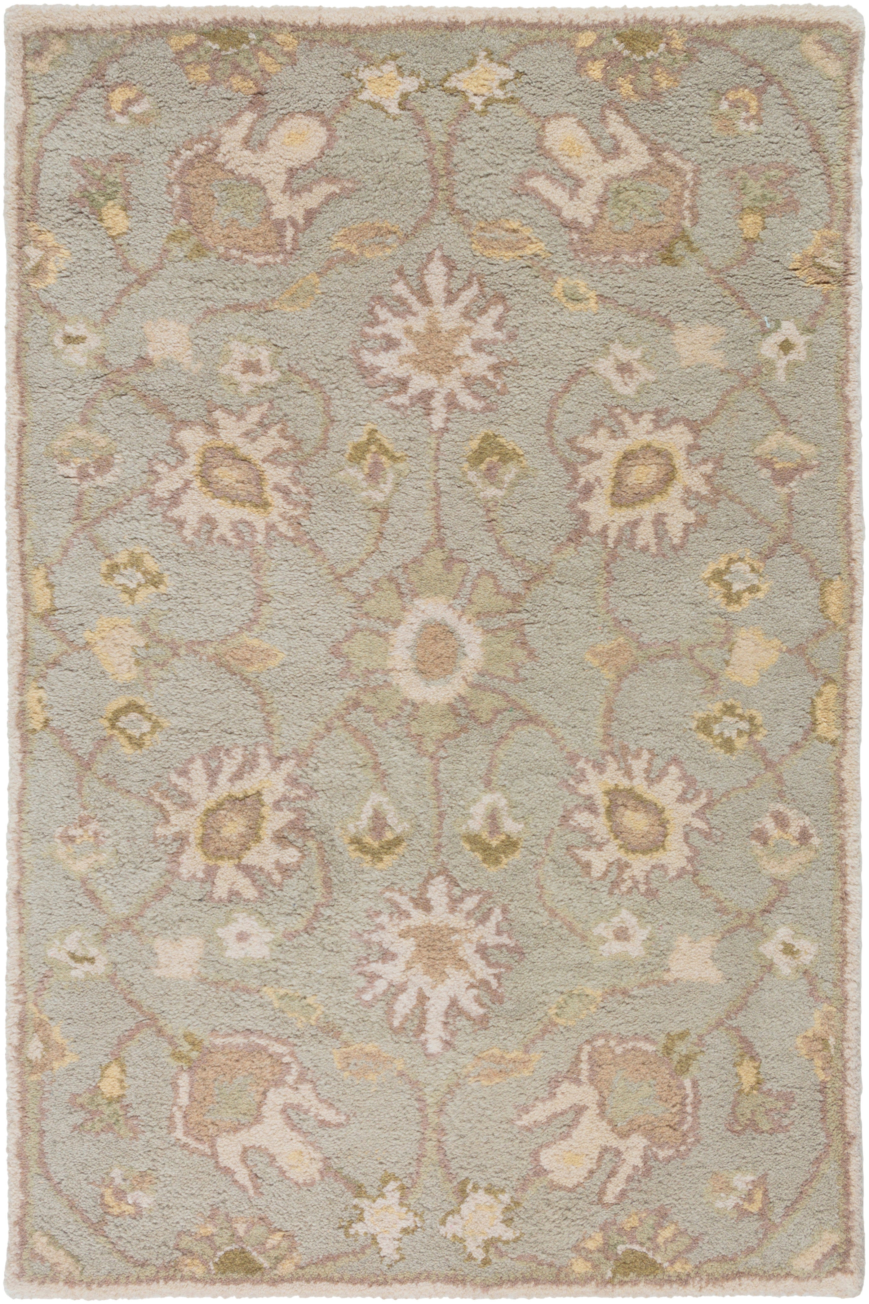 Giardino Stone hand-tufted wool rug with a floral pattern in blue-grey, beige, and gold.