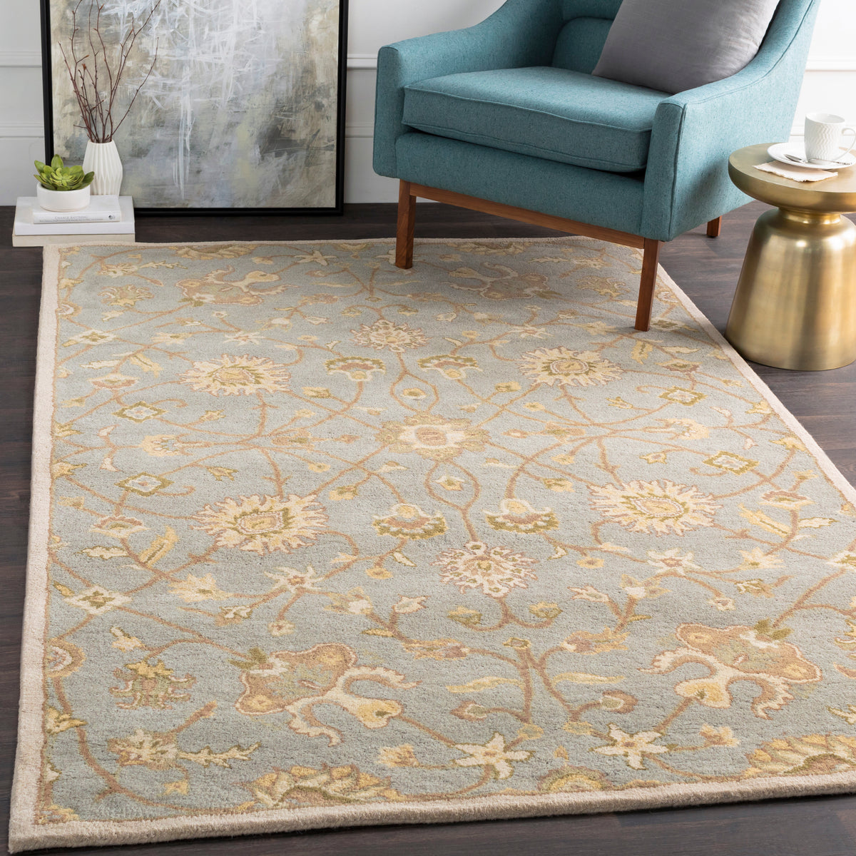 Giardino Stone hand-tufted wool rug with a blue-grey floral pattern in a living room.