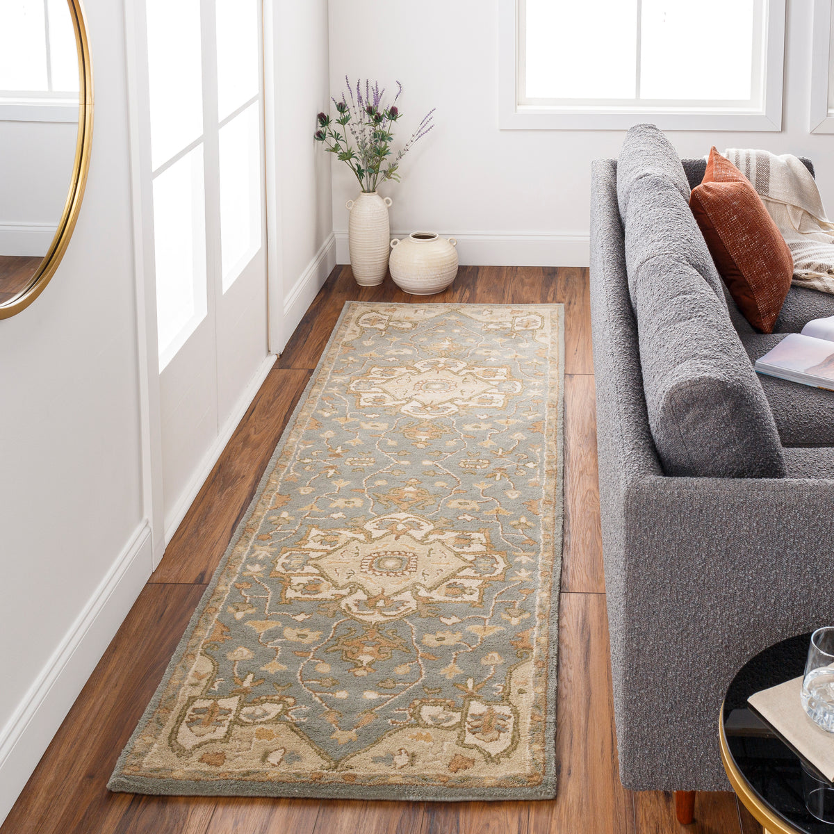 Roman Stone hand-tufted wool runner rug in blue-grey with tan and sage accents.