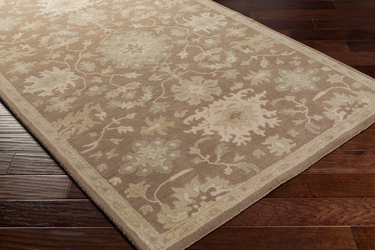 Julian Sand hand-tufted wool rug with a warm beige floral pattern on dark wood floors.