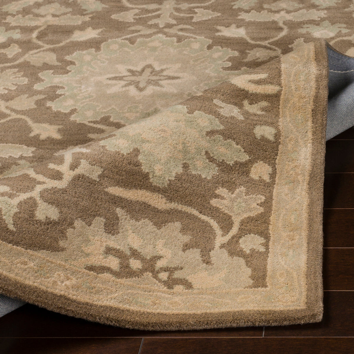 Julian Sand hand-tufted wool rug with a warm sand and sage green floral pattern.