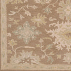 Julian Sand hand-tufted wool rug with a warm beige floral and vine pattern.