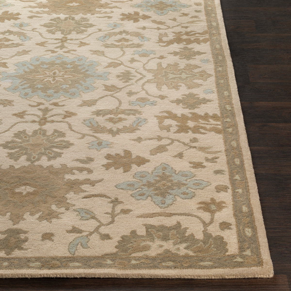 Julian Natural Hand-Tufted wool rug with beige and blue floral patterns on dark wood floor
