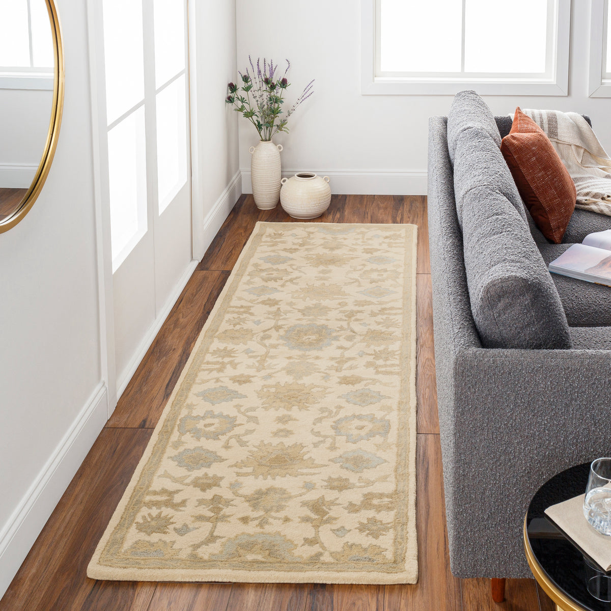 Julian Natural Hand-Tufted wool runner rug with a beige floral pattern in a living room hallway.