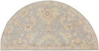 Julian Arctic half-round hand-tufted wool rug with light blue and beige floral patterns.