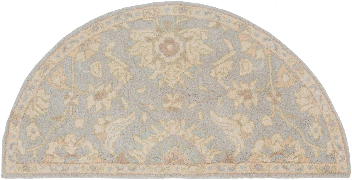 Julian Arctic half-round hand-tufted wool rug with light blue and beige floral patterns.